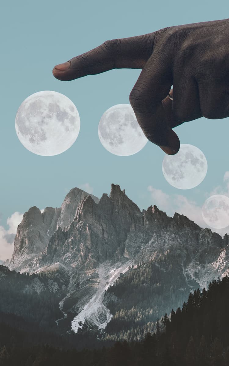A hand is pointing at a fading moon on top of mountains and a forest