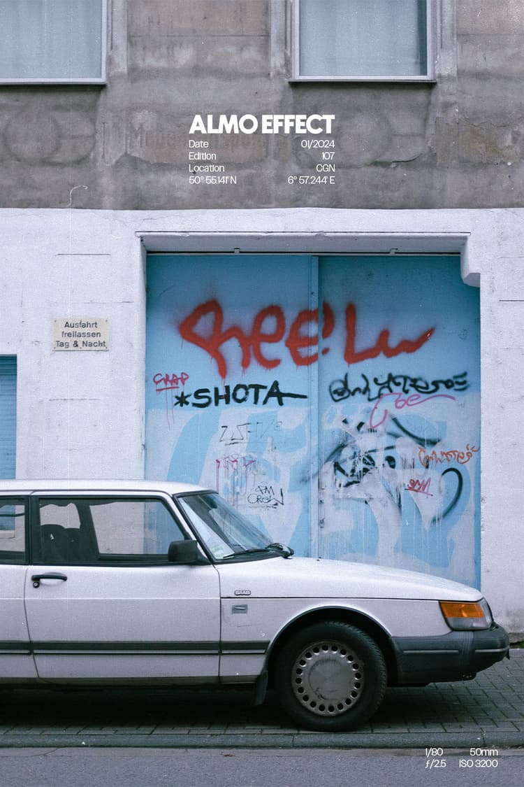 This classic young timer car in front of a garage door in the middle of cologne is another example for the beauty of the everyday life and the small moments we try to cheerish more. There is an old white Saab and a light blue garage door in a white and beige building. The building is old and a littte bit crooked and full of graffiti. The graffiti creates a nice color contrast to the warm tones of the building as well as of the garage door. The Saab perfectly integrates into this look.