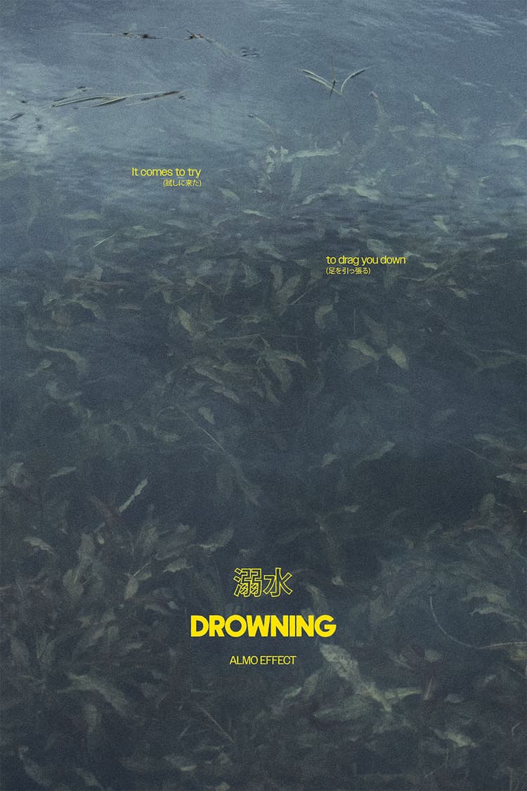 A dark, murky underwater scene with plants and debris floating beneath the surface. Yellow text overlays the image, with the words 'It comes to try' and 'to drag you down' written in English and Japanese. At the bottom of the image, the word 'DROWNING' appears in bold yellow text, accompanied by the Japanese word for 'drowning' and 'ALMO EFFECT' in smaller text.